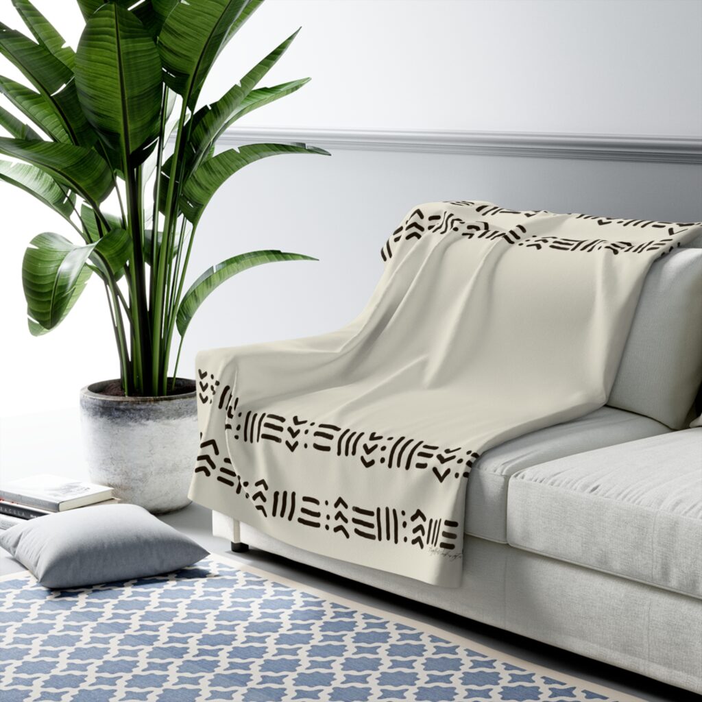 Harlem Collection fleece throw blanket on a sofa.